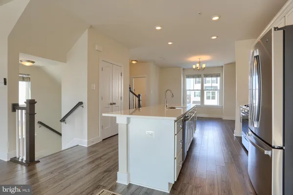 a kitchen with counter top space and wooden floor