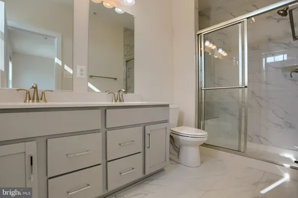 a bathroom with a toilet sink and a mirror