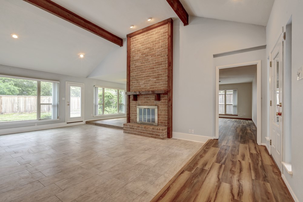 17 Wishbonebush Road Spring, TX 77380 - Photo 15 of 36 a view of a hallway with wooden floor and a fireplace