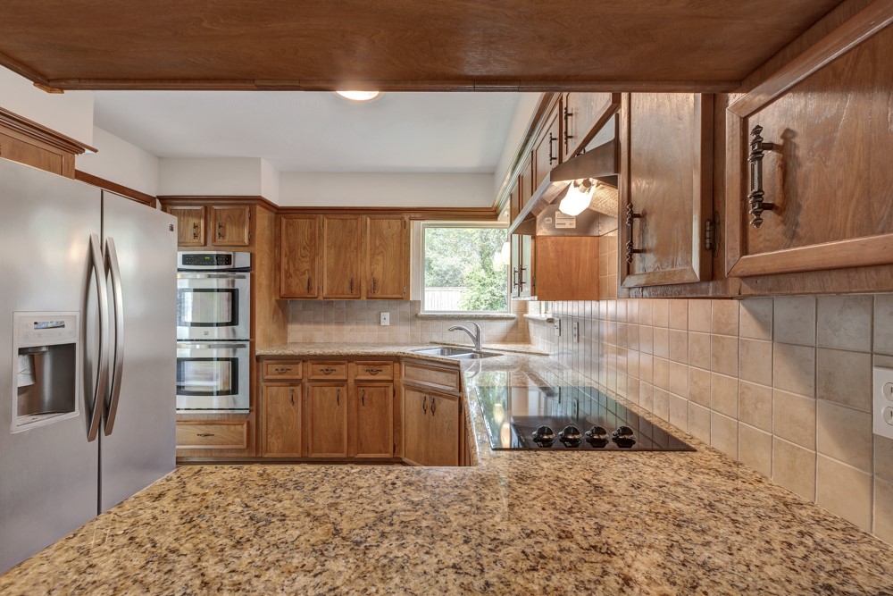 17 Wishbonebush Road Spring, TX 77380 - Photo 23 of 36 a kitchen with stainless steel appliances granite countertop a refrigerator and a sink