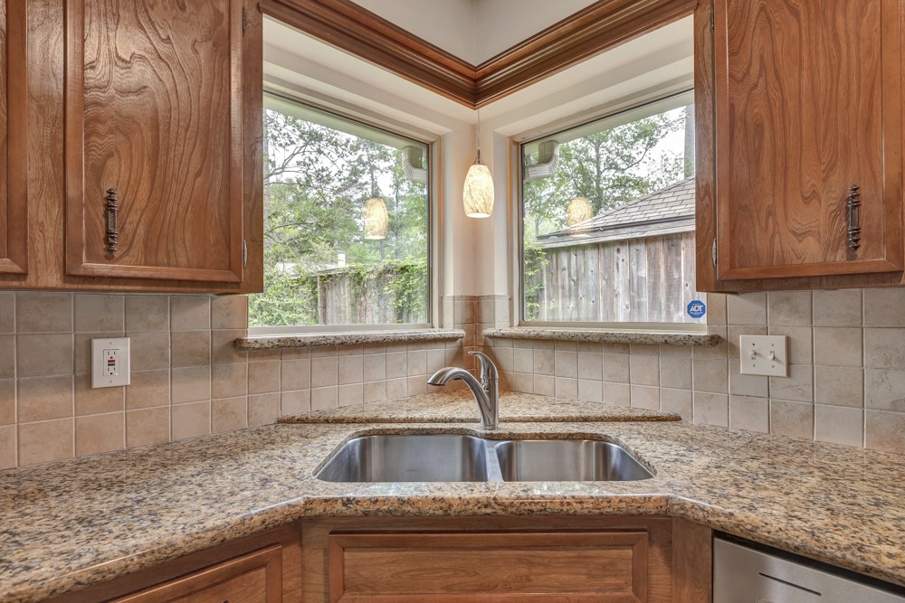 17 Wishbonebush Road Spring, TX 77380 - Photo 26 of 36 a kitchen with granite countertop a sink window and cabinets