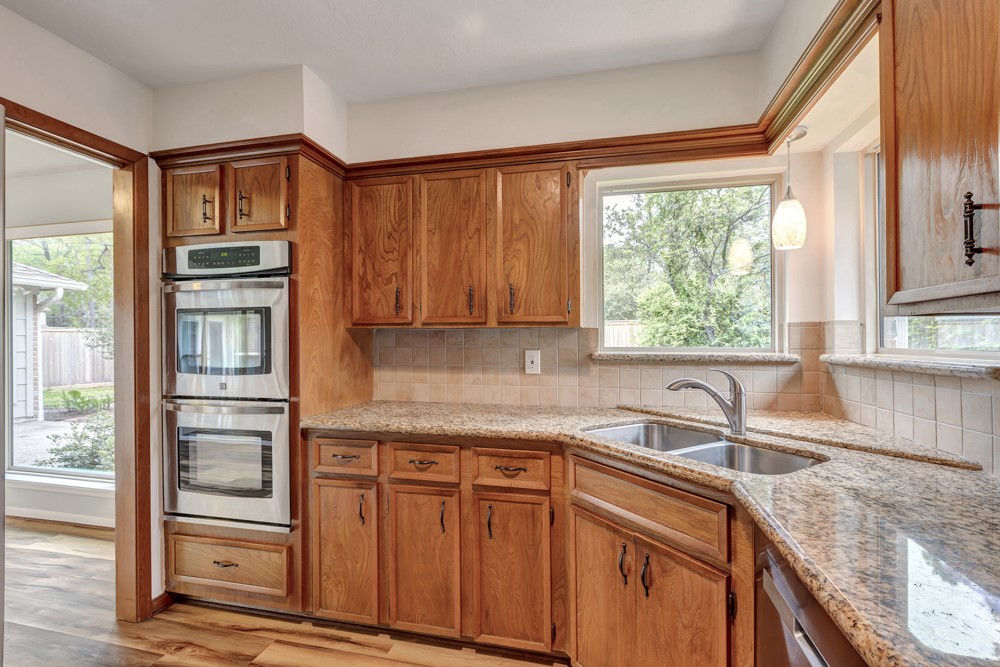 17 Wishbonebush Road Spring, TX 77380 - Photo 27 of 36 a kitchen with stainless steel appliances granite countertop a refrigerator and a sink