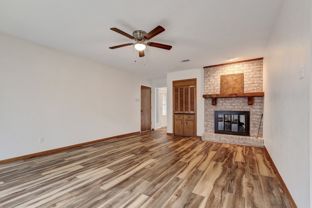 17 Wishbonebush Road Spring, TX 77380 - Photo 28 of 36 a view of an empty room with wooden floor fireplace and a window