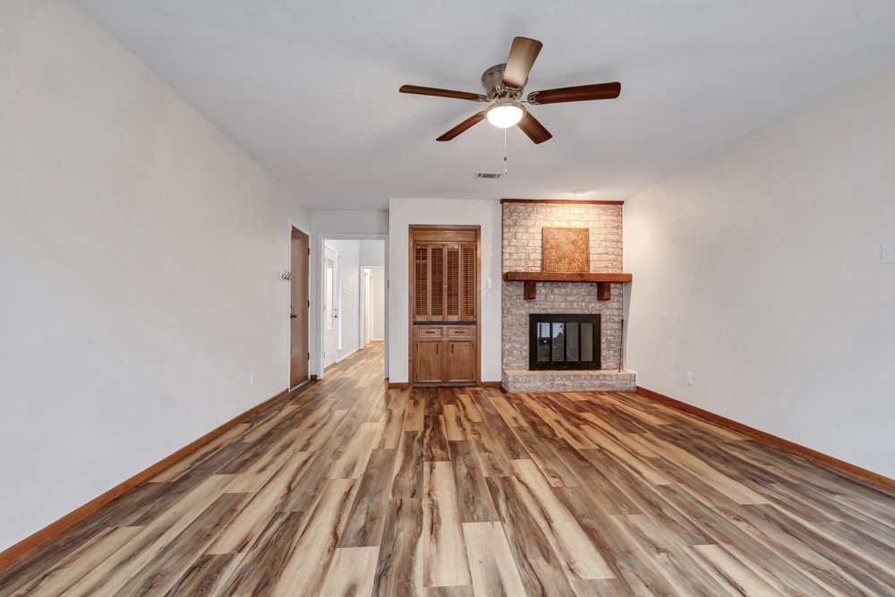 17 Wishbonebush Road Spring, TX 77380 - Photo 29 of 36 wooden floor in an empty room with a fireplace