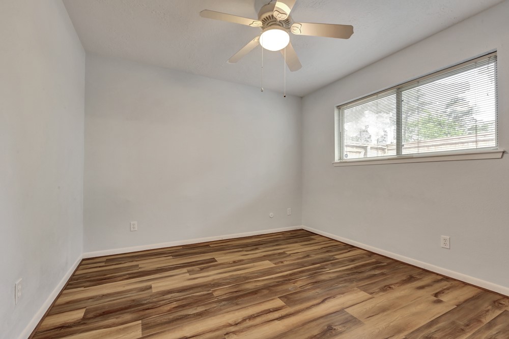 17 Wishbonebush Road Spring, TX 77380 - Photo 5 of 36 a view of empty room with wooden floor and fan