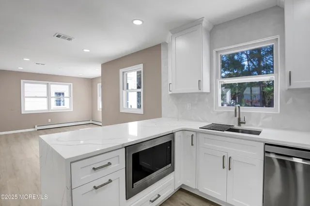 a kitchen with a sink stove and microwave