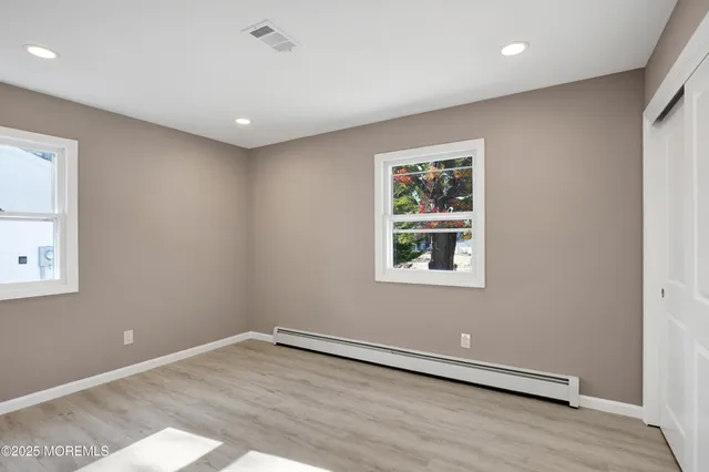 en empty room with wooden floor and window