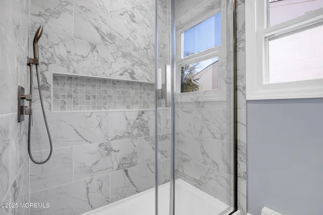 a bathroom with a glass shower door