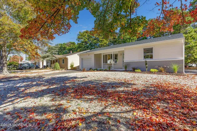 a backyard of a house with large trees and brick walls