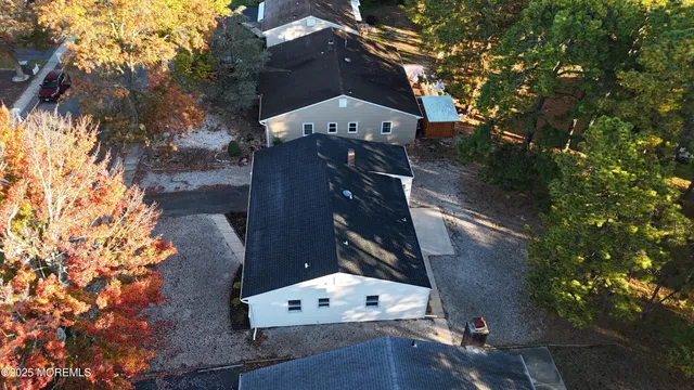 an aerial view of a residential houses with yard