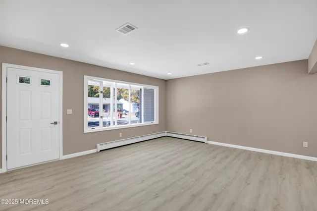 wooden floor in an empty room with window