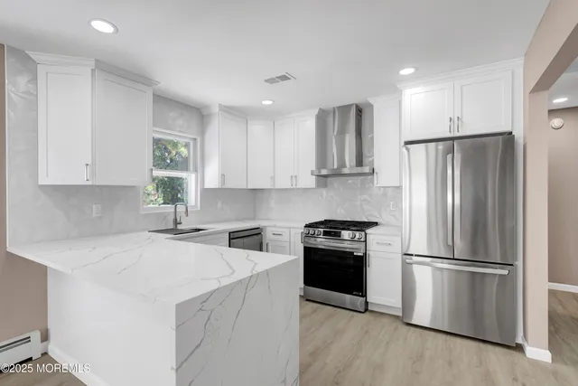 a kitchen with stainless steel appliances granite countertop a refrigerator a sink a stove a microwave and island