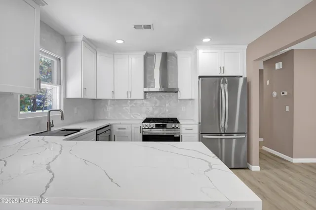 a kitchen with a refrigerator a stove a microwave and cabinets