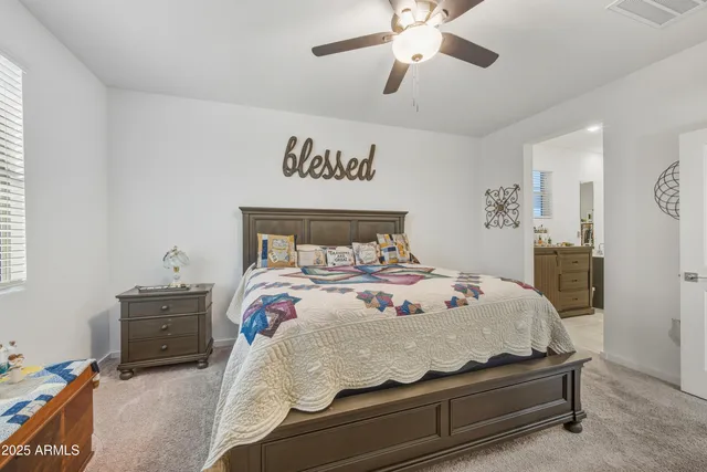 a bedroom with a bed and a ceiling fan