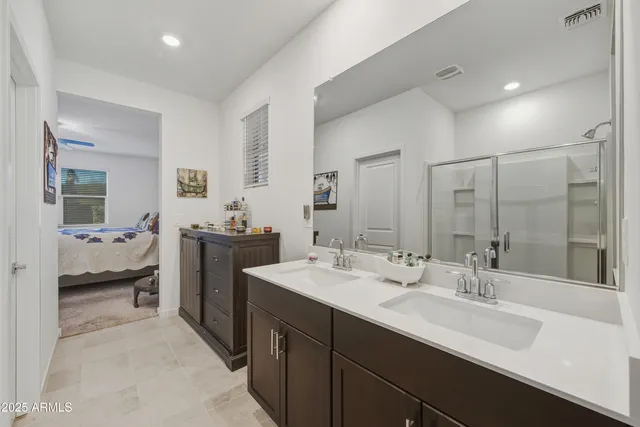 a en suite bathroom with double sink and a mirror