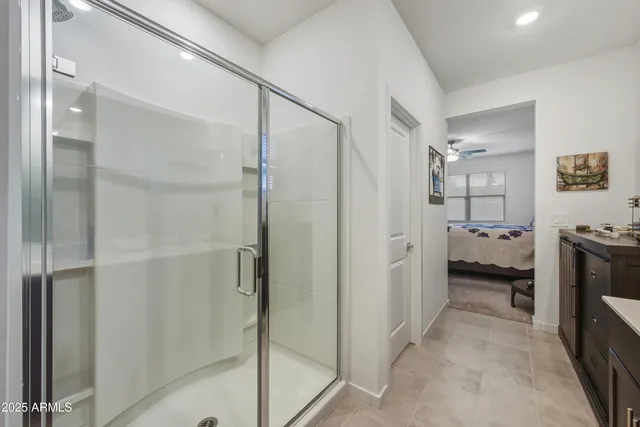 a bathroom with a double vanity sink and shower