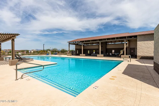 a view of swimming pool with chairs