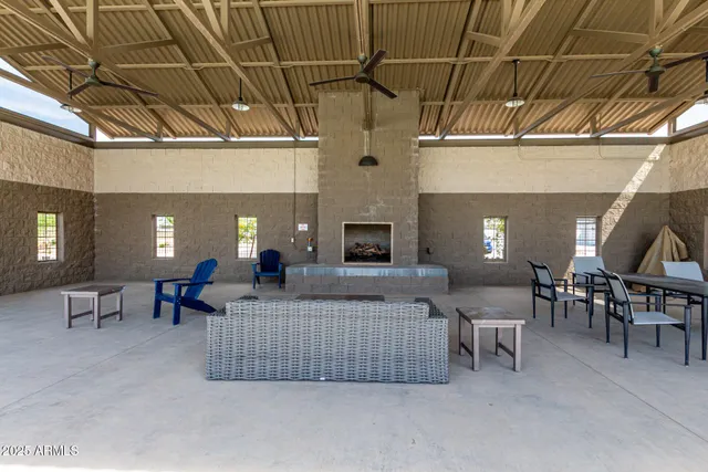 a living room with furniture a dining table and a fireplace