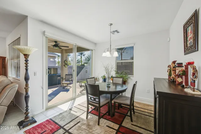 a view of a dining room with furniture and chandelier