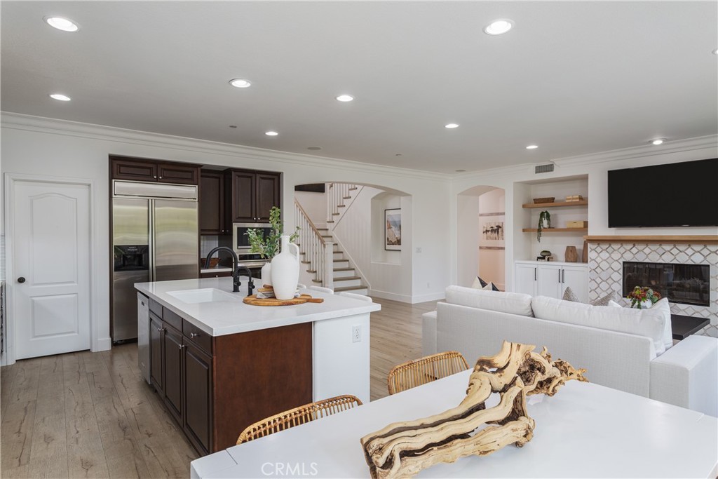 308 Via Los Tilos San Clemente, CA 92673 - Photo 13 of 43 a large living room with stainless steel appliances kitchen island granite countertop a couch and a flat screen tv