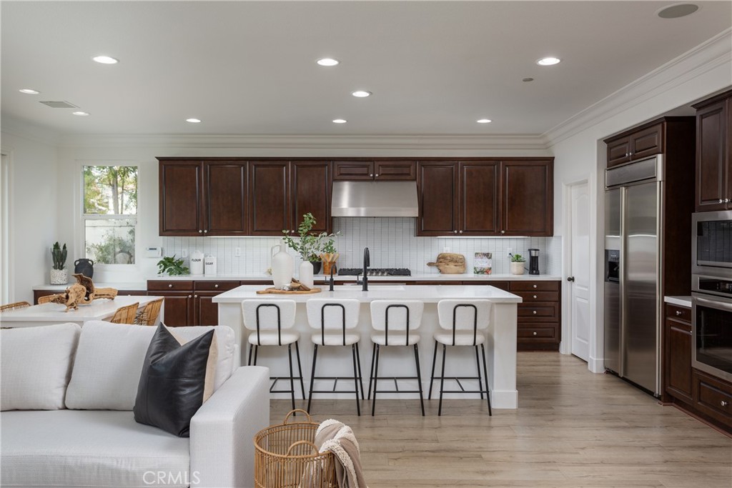 308 Via Los Tilos San Clemente, CA 92673 - Photo 9 of 43 a kitchen with granite countertop a refrigerator and wooden cabinets