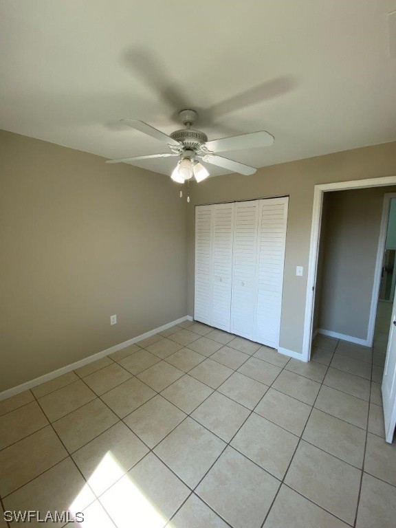18258 Maple Road Fort Myers, FL 33967 - Photo 7 of 14 an empty room with a ceiling fan and carpet