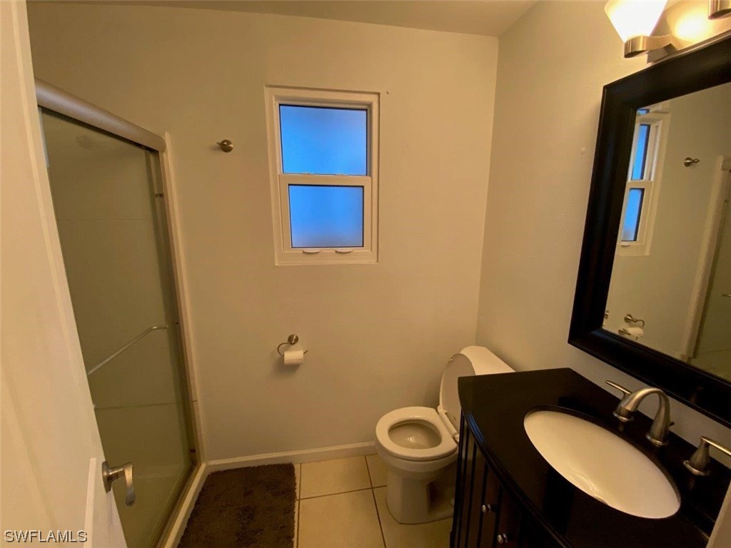 18258 Maple Road Fort Myers, FL 33967 - Photo 8 of 14 a bathroom with a sink toilet and mirror