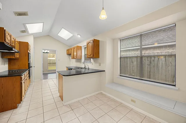 a kitchen with stainless steel appliances granite countertop a sink and cabinets