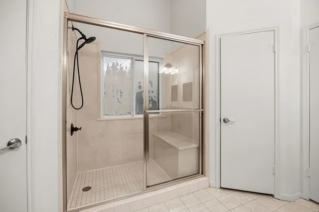 a bathroom with a glass shower door