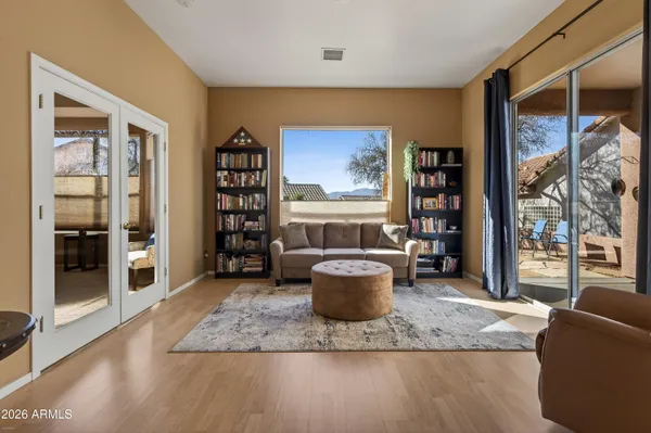 a living room with furniture a window and a potted plant