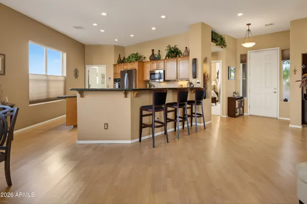 a open kitchen with stainless steel appliances granite countertop a refrigerator and a stove top oven