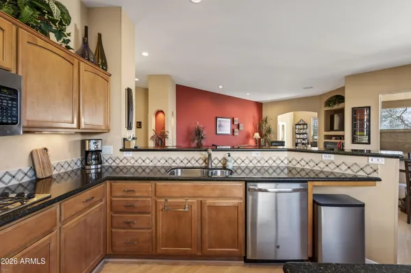 a kitchen with granite countertop a sink and cabinets