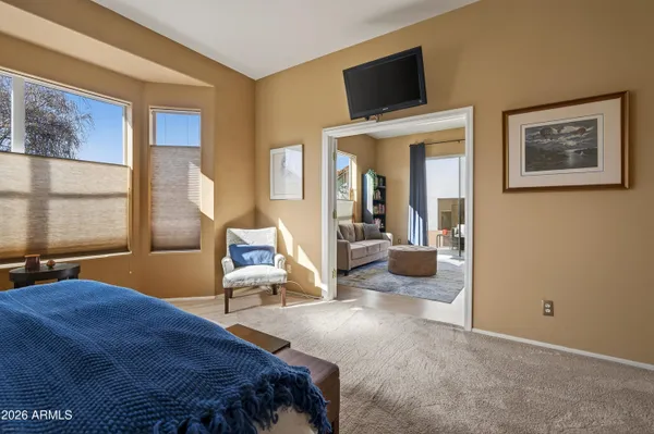 a bedroom with a bed and glass windows