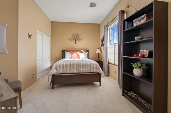 a bedroom with a bed and closet