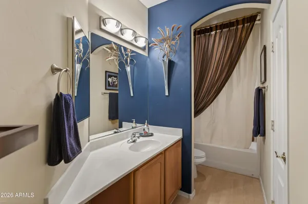 a bathroom with a sink vanity and a mirror