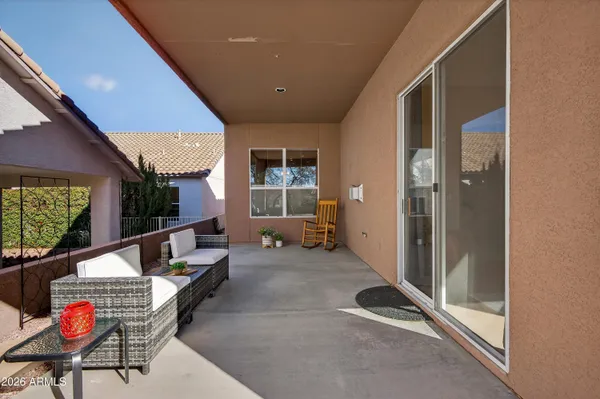 a living room with furniture a rug and a window