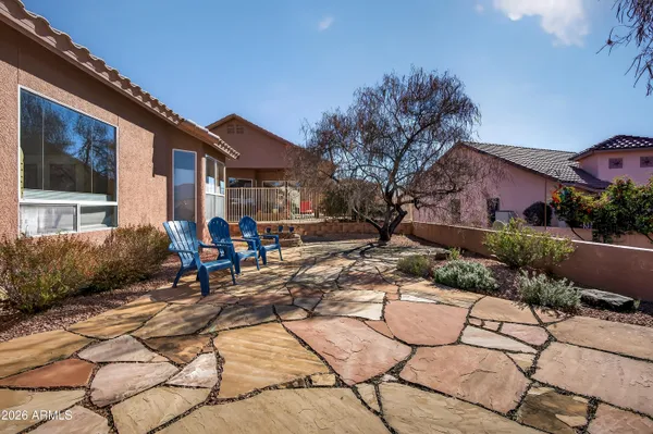 a view of a house with backyard sitting area and garden