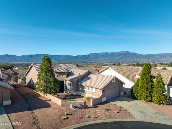 an aerial view of a house with a yard