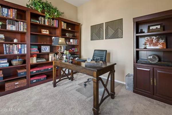 a view of a workspace with bookshelf