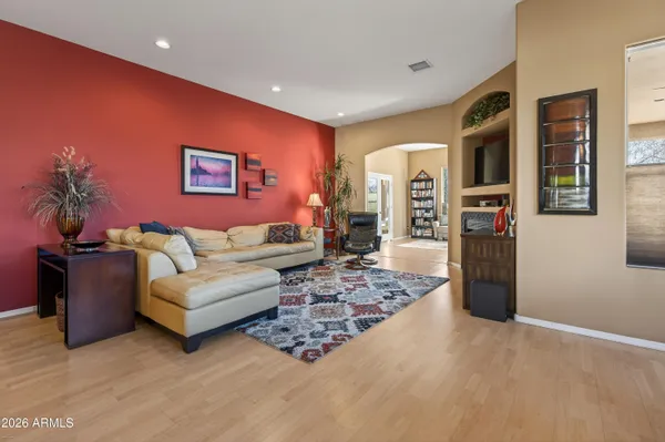 a living room with furniture rug and wooden floor