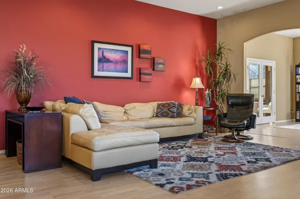 a living room with furniture a couch and a flat screen tv