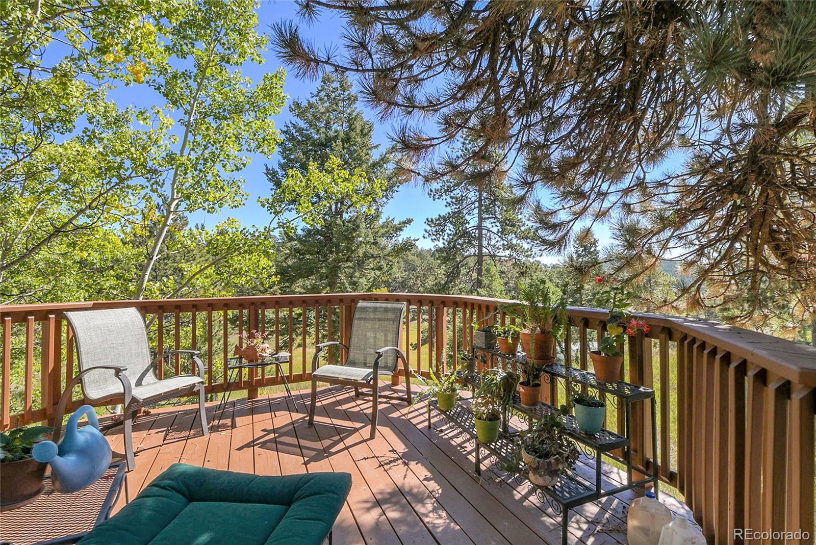 13082 South Wamblee Valley Road Conifer, CO 80433 - Photo 33 of 35 a balcony with wooden floor and outdoor seating