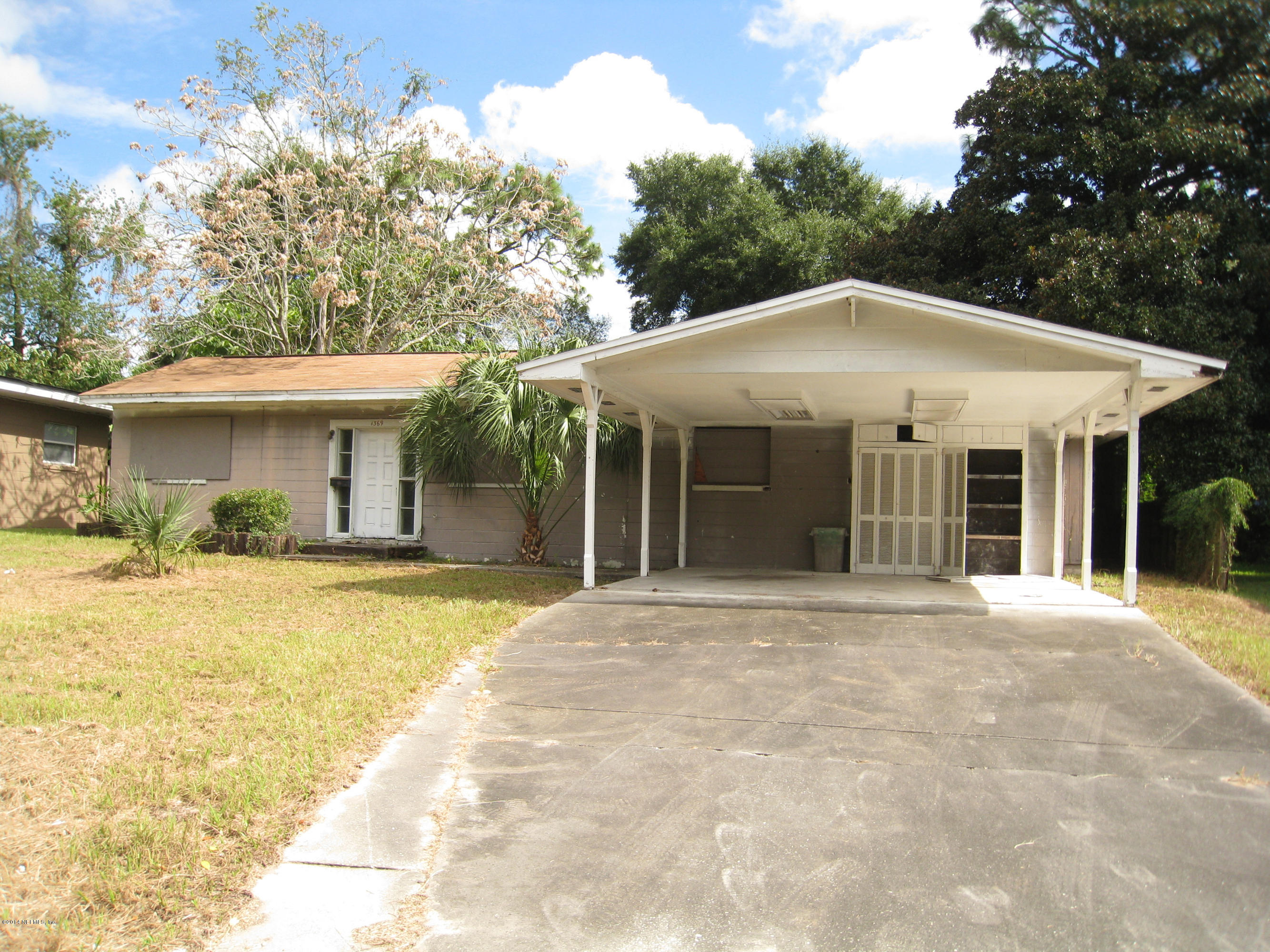 1369 Griflet Road Jacksonville, FL 32211 - Photo 1 of 16 a front view of a house with a garden