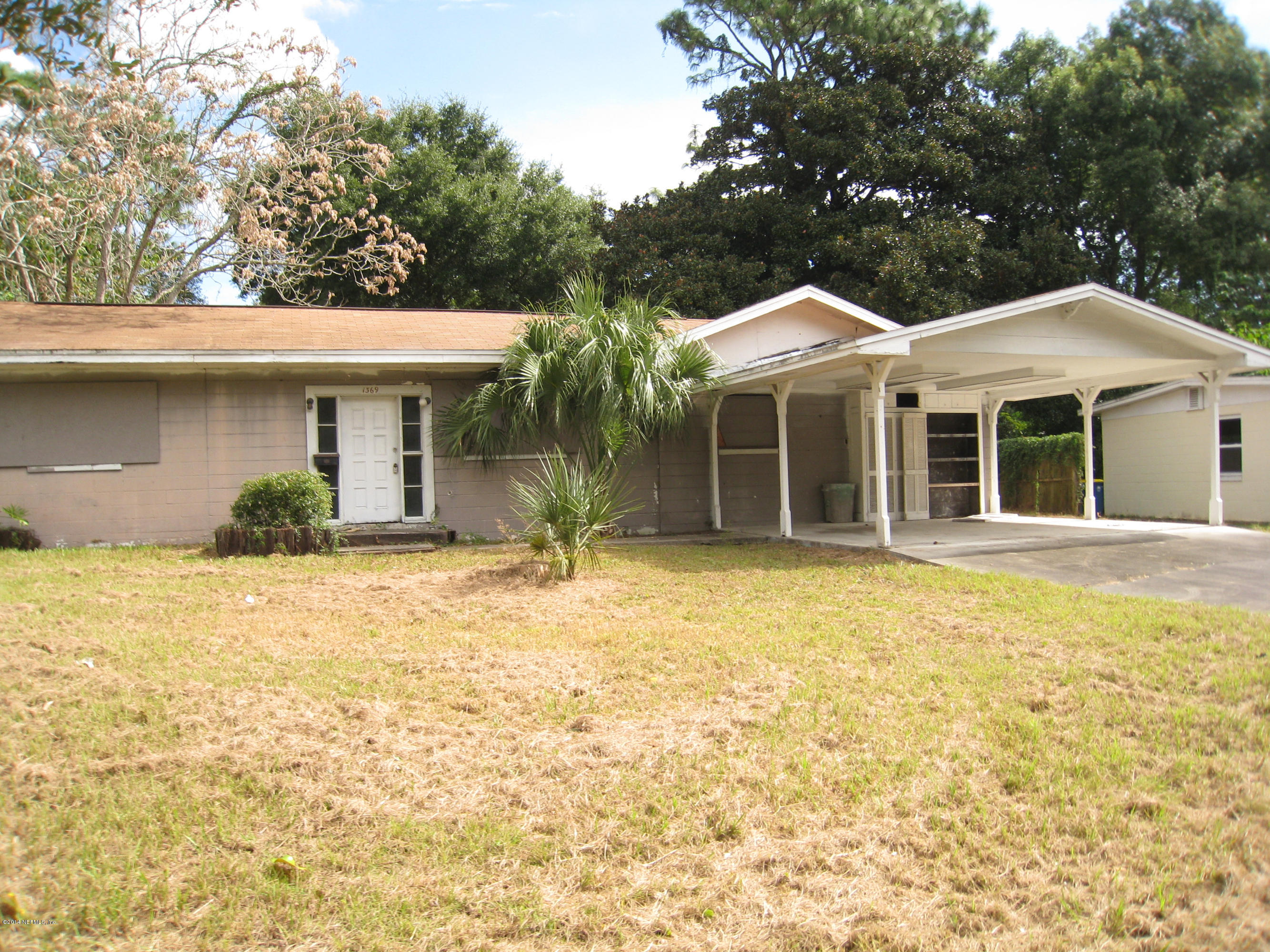 1369 Griflet Road Jacksonville, FL 32211 - Photo 2 of 16 a front view of a house with a garden