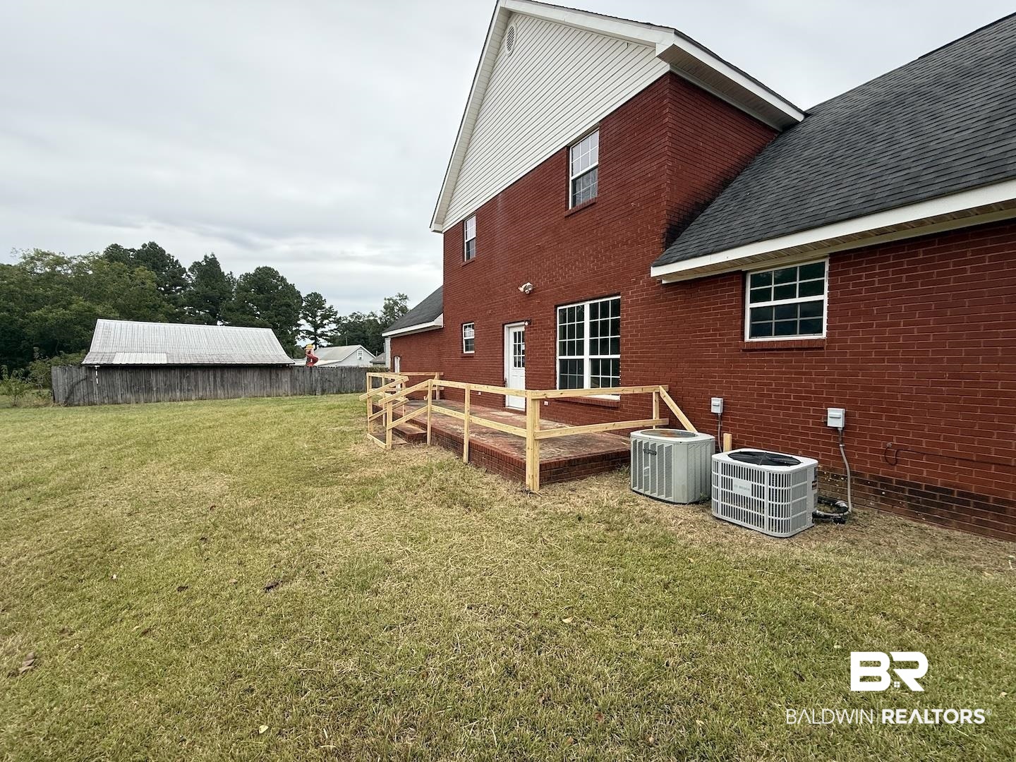 99 Cemetery Street Uriah, AL 36480 - Photo 13 of 13 Back of property with a deck, a lawn, brick siding, and roof with shingles