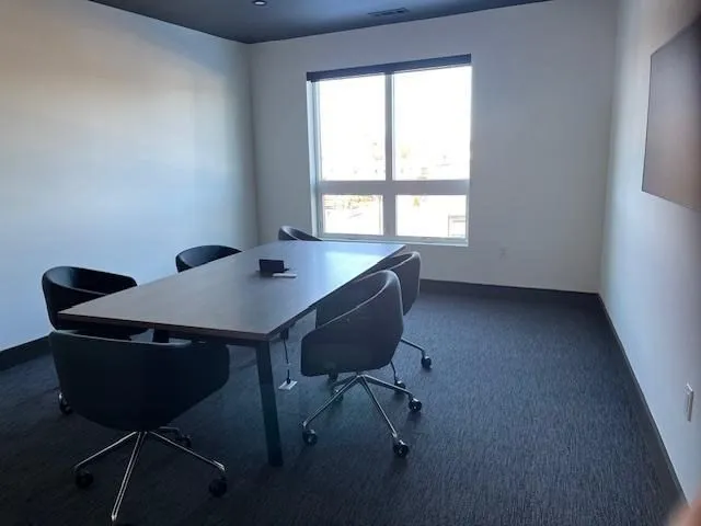 a workspace with furniture and a window