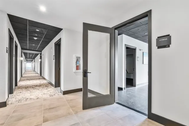 a view of a hallway to rooms