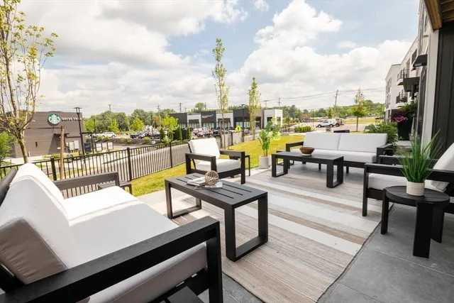 an outdoor sitting area with furniture and city view