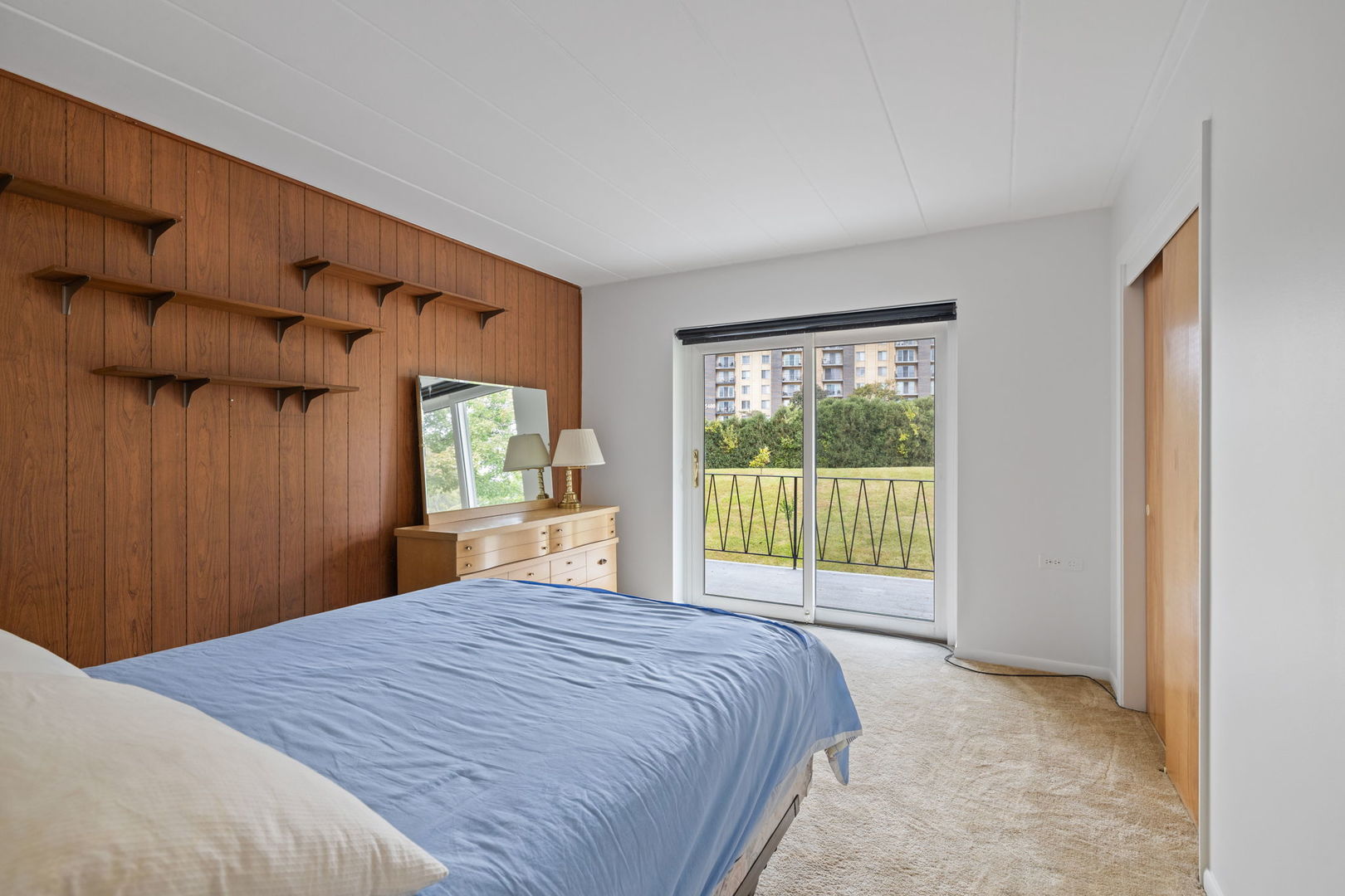 5540 Walnut Avenue, Unit 11B Downers Grove, IL 60515 - Photo 4 of 27 a bed sitting in a bedroom next to a window