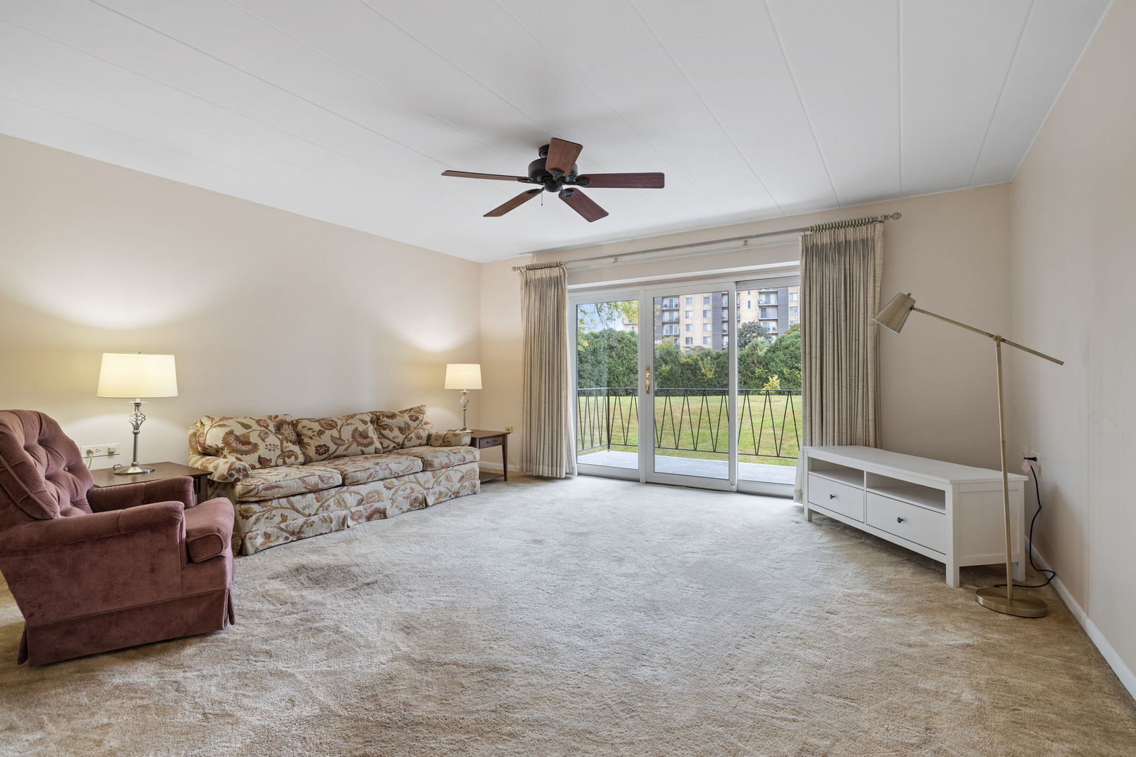 5540 Walnut Avenue, Unit 11B Downers Grove, IL 60515 - Photo 6 of 27 a living room with furniture ceiling fan and a window